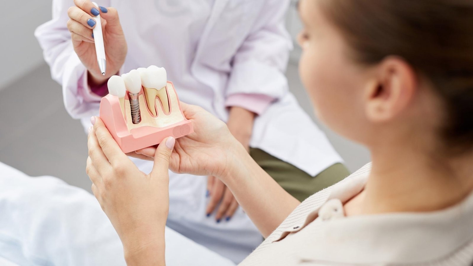 Woman looking at a representation of dental implants